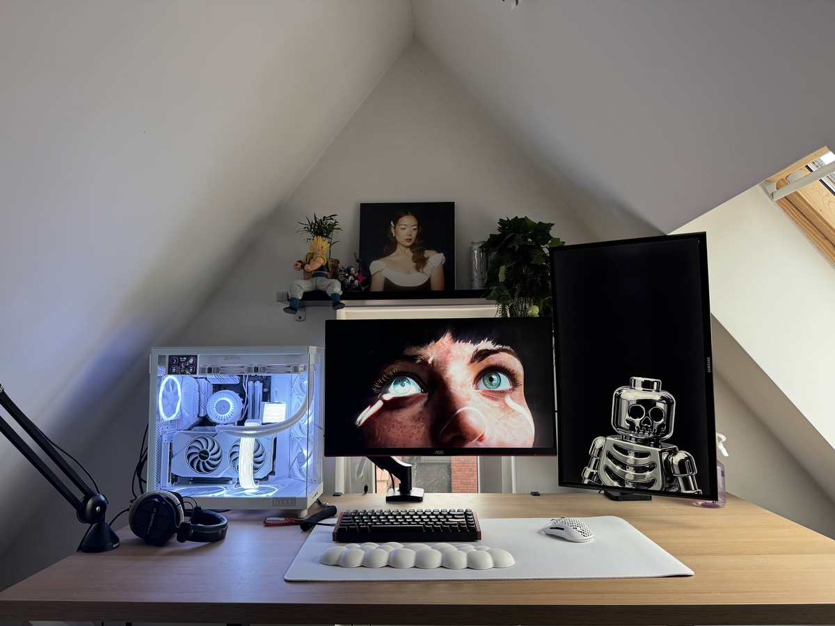 Setups contest winner: an attic desk with a white dual-chamber PC, two monitors (one vertical) and a white desk mat