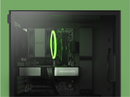 A close-up view of a computer’s interior shows a GeForce RTX graphics card, a motherboard, and a green-lit cooling fan inside a black NZXT case against a green background.