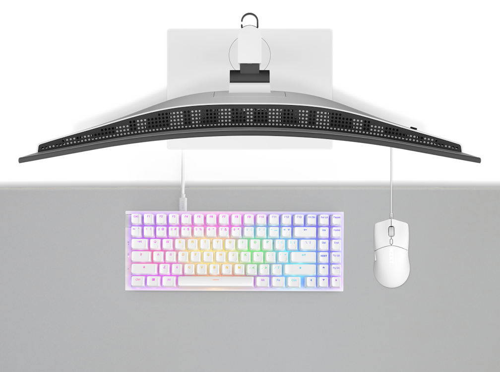 Top view of a computer setup with a curved monitor, a rainbow-backlit keyboard, and a white mouse on a light grey desk. The monitor is mounted above the keyboard and mouse.