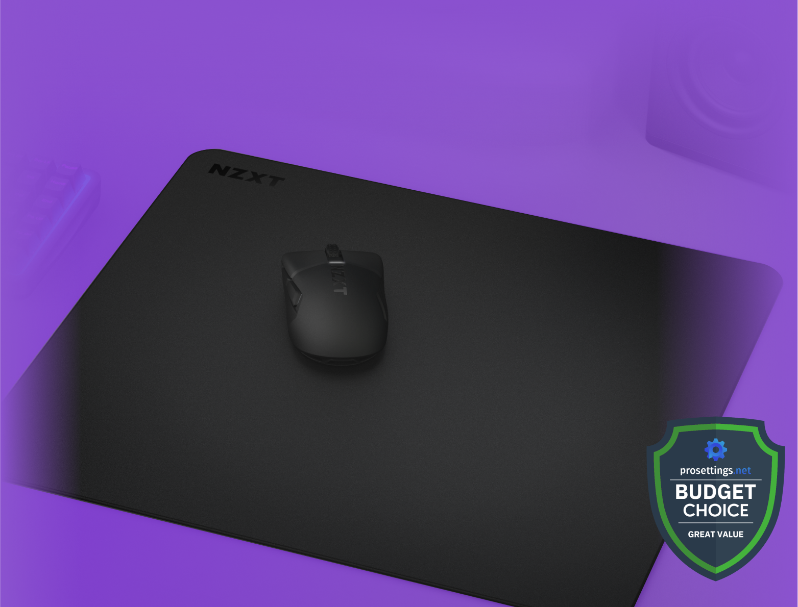 A black NZXT mouse and mouse pad are centered on a purple background, with a Budget Choice badge from Prosettings.net in the lower right corner. A keyboard and speaker are blurred in the background.